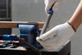 Male hobby retirement. Senior man is using rasp on wood for assembling hammer handle