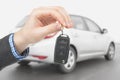 Male holding car keys with remote control system Royalty Free Stock Photo