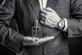 Male holding up bottle perfume. Hand in with wrist watch in a business suit. Perfume or cologne bottle and perfumery