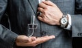 Male holding up bottle perfume. Hand in with wrist watch in a business suit. Perfume or cologne bottle and perfumery