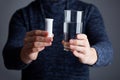 Male holds pills ready to dissolve one in water Royalty Free Stock Photo