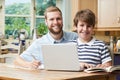 Male Home Tutor Helping Boy With Studies