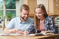 Male Home Tutor Helping Teenage Girl With Studies