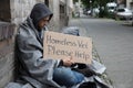 Male Homeless Sitting On A Street Asking For Help
