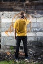 Male hooligan painting graffiti Royalty Free Stock Photo