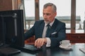 Male hotelier works at a computer while sitting in his office in a hotel Royalty Free Stock Photo