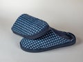 Male house slippers with a checkered pattern in gray shades. A pair of men's slippers for the house. Modern indoor Royalty Free Stock Photo