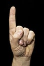 A male human hand on black background one index finger pointing up Royalty Free Stock Photo