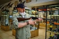 Male hunter reloads rifle in gun store