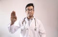 Male indian doctor in white coat and stethoscope swearing hippocratic oath