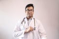 Male indian doctor in white coat and stethoscope swearing hippocratic oath