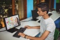 Male indian student having a video call with female teacher on computer at school Royalty Free Stock Photo