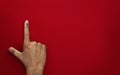 Male Indian Voter Hand with voting sign or ink pointing vote for India on red background with copy space election commission of In