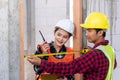 Male industrial builder workers installation process measuring wooden door with measure tape Royalty Free Stock Photo