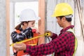 Male industrial builder workers installation process measuring wooden door with measure tape Royalty Free Stock Photo