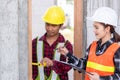 Male industrial builder workers installation process measuring wooden door with measure tape Royalty Free Stock Photo