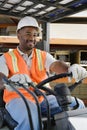 Male Industrial Worker Driving Forklift At Workplace Royalty Free Stock Photo