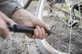 Male inflates bicycle wheel with a pump. Royalty Free Stock Photo