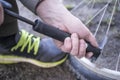 Male inflates bicycle wheel with a pump. Royalty Free Stock Photo