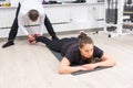 Instructor attaching womans ankle to black harness