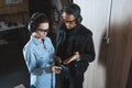 male instructor describing gun to female customer Royalty Free Stock Photo