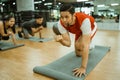 male instructor giving examples of movements to train the abdominal muscles