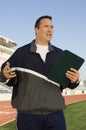 Male Instructor Holding Clipboard