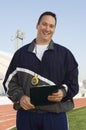 Male Instructor Holding Clipboard