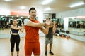 male instructor leading exercise with arm muscle stretching movements Royalty Free Stock Photo