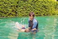 Male instructor swimming for children teaches a happy boy to swim in the pool Royalty Free Stock Photo