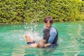 Male instructor swimming for children teaches a happy boy to swim in the pool Royalty Free Stock Photo