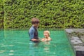 Male instructor swimming for children teaches a happy boy to swim in the pool Royalty Free Stock Photo