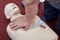 Close-up of male instructor teaching cardiopulmonary resuscitation with CPR dummy Royalty Free Stock Photo