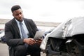 Male Insurance Loss Adjuster With Digital Tablet Inspecting Damage To Car From Motor Accident Royalty Free Stock Photo