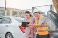 male insurance officer came to help inspect a customer's car that had an accident.