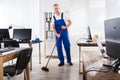 Male Janitor Cleaning Floor With Broom Royalty Free Stock Photo