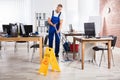 Male Janitor Cleaning Floor With Mop Royalty Free Stock Photo