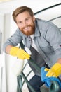 male janitor cleaning staircase with mop Royalty Free Stock Photo