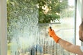 Male janitor cleaning window with squeegee Royalty Free Stock Photo