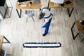 Male Janitor Mopping Floor In Face Mask Royalty Free Stock Photo