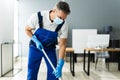 Male Janitor Mopping Floor In Face Mask Royalty Free Stock Photo