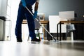 Male Janitor Mopping Floor In Face Mask