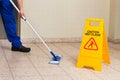 Male Janitor Mopping Floor Royalty Free Stock Photo