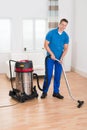 Male Janitor Vacuuming Floor