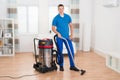 Male Janitor Vacuuming Floor Royalty Free Stock Photo