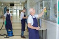 Male janitorial staff cleaning establishment