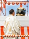 A male Japanese musician, a drummer standing on the stage Yagura is dressed in traditional Japanese holiday kimono and