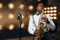 Male jazz performer plays the saxophone on stage Royalty Free Stock Photo