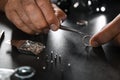 Male jeweler examining  ring in workshop, closeup view Royalty Free Stock Photo