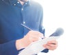 Male journalist at news conference, holding microphone and taking notes